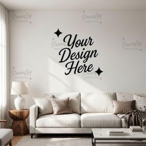 May include: A contemporary living room scene featuring a white sofa with cushions, a wooden side table, and a lamp. The wall displays the text "Your Design Here" in black script. The room has a neutral colour palette.