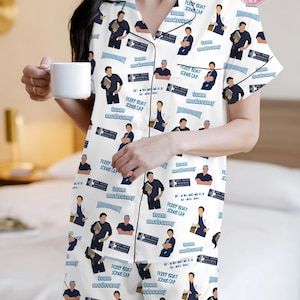 May include: White pajama set with a black trim, featuring a repeating pattern of cartoon characters, text that says "team medreamy", "Ferry Boat Scrub Cap", and "It's a beautiful day to save lives".