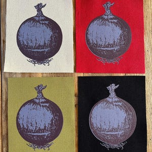 May include: Four fabric squares with a purple onion illustration. The onion design is printed on cream, red, olive green, and black backgrounds. The onion has a detailed root system and stem.