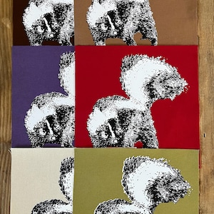 May include: Six square fabric panels featuring a black and white screen-printed skunk illustration. The background colors include dark brown, light brown, purple, red, cream, and olive green. Each panel displays the same skunk graphic.