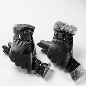 May include: A pair of black leather gloves with a faux fur trim. The gloves have a buckle closure and a quilted design on the back of the hand. The gloves are designed for cold weather and are a winter accessory.