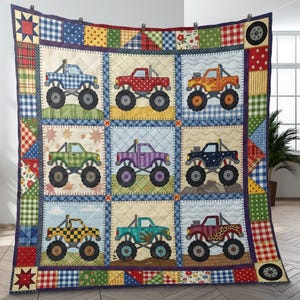 May include: A patchwork quilt featuring nine squares, each showcasing a different monster truck design. The trucks vary in color and pattern, set against a background of quilted squares. The quilt's border includes plaid, floral, and star patterns.