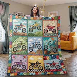 Puede incluir: Un edredón colorido con nueve cuadrados, cada uno mostrando un diseño diferente de moto de motocross. Las motos son de varios colores, sobre fondos de paisajes, nubes y patrones. El edredón tiene un borde de patchwork.