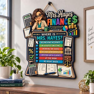 May include: A decorative wall sign titled Mrs. Hayes Finance featuring a cartoon accountant, a calculator, a ledger, and a status board with options like Reconciling Accounts, In a Budget Meeting, Working on Taxes, Checking Spreadsheets, and At the Bank.