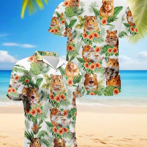 May include: White Hawaiian shirt featuring a repeating pattern of hamsters, tropical flowers, and green leaves. The shirt has a button-down front and short sleeves. The background shows a beach scene with palm trees and blue water.