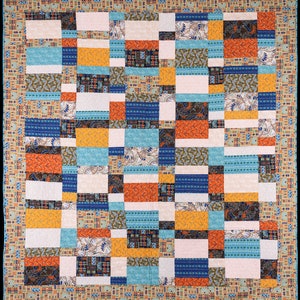 May include: A patchwork quilt with a geometric pattern of squares in shades of blue, orange, brown, and white. The quilt is made of different fabrics with various patterns and textures.