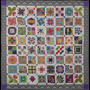 May include: A colorful quilt with a patchwork design featuring various geometric shapes and patterns. The quilt is made up of squares and rectangles, each with a different fabric and design. The quilt is framed with a decorative border.