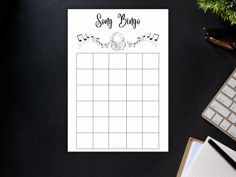 May include: A black and white Song Bingo game sheet. The top of the sheet features the words "Song Bingo" in a script font, along with musical notes and headphones. The sheet is divided into a grid of 25 squares.