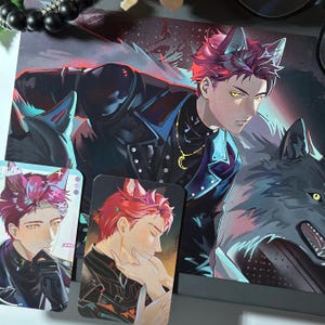 May include: An anime-style illustration featuring a character with red hair and wolf ears, wearing a black leather jacket and a gold crescent moon necklace, accompanied by a wolf, alongside two smaller rectangular cards depicting the same character.
