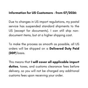 May include: A white informational notice with black text titled Information for US Customers - from 07/2026. The text explains changes in US import regulations, the suspension of standard shipments, and the use of Delivered Duty Paid shipping.