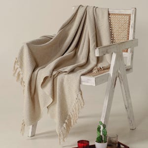 Urbane Hide | Handgewebter Sofaüberwurf aus Baumwolle | Beige Fischgrätenmuster Plaid mit Quasten | Tagesdecke aus Baumwolle | 130x150 cm