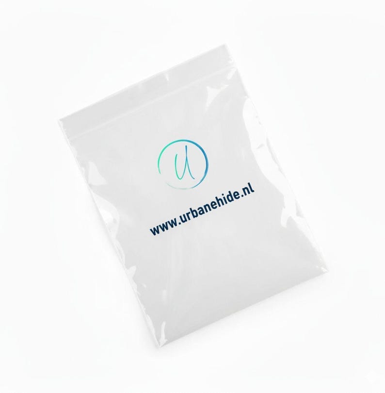 May include: A clear plastic bag with a white background. The bag has a logo with a blue and green design and the text "www.urbanehide.nl" in blue.