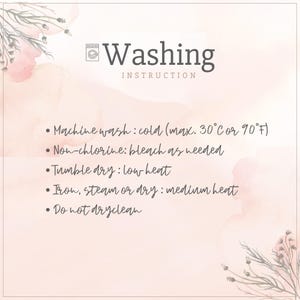 May include: A light pink and white card with washing instructions. The text includes machine wash cold, non-chlorine bleach, tumble dry low heat, iron medium heat, and do not dry clean. Floral accents are in the corners.