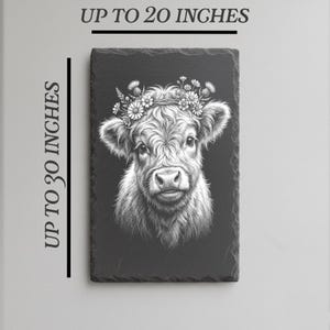 May include: A rectangular slate featuring a detailed black and white illustration of a Highland cow wearing a floral crown. The artwork is up to 30 inches tall and 20 inches wide.