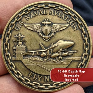 May include: A bronze-colored coin featuring the text "U.S. NAVAL AVIATION" and "FLY NAVY". The coin depicts an aircraft carrier, a jet taking off, and the U.S. Navy wings emblem. The coin has a chain-link border and a red banner with text.
