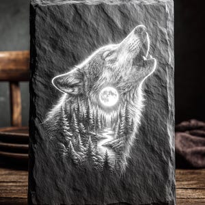 May include: A rectangular black slate plaque with a detailed white engraving of a howling wolf. The wolf's silhouette incorporates a forest scene with a full moon. The text "LASER READY PNG" is at the top.