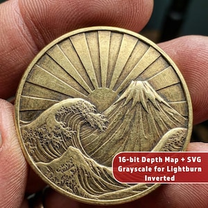 May include: A round, bronze-colored coin featuring a detailed relief of a rising sun, a mountain, and ocean waves. The coin has the text "16-bit Depth Map + SVG Grayscale for Lightburn Inverted" on a red label.