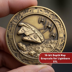 May include: A circular brass-toned medallion featuring a relief of a starship flying over a cratered moon surface with three smaller fighter ships. The border has a gear-like pattern. Text on the lower right reads 16-bit Depth Map Grayscale for Lightburn STL.