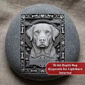May include: A gray stone with a carved relief of a dog with angel wings, framed with decorative elements including bones and hearts. The text "16-bit Depth Map Grayscale for Lightburn Inverted" is in a red box at the bottom.