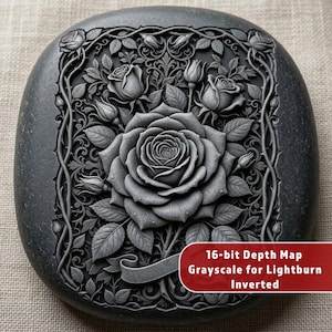 May include: A grayscale, square-shaped stone with a detailed relief carving of roses and leaves. The central rose is fully bloomed, surrounded by buds and foliage within a decorative border. The text "16-bit Depth Map Grayscale for Lightburn Inverted" is on a red banner.