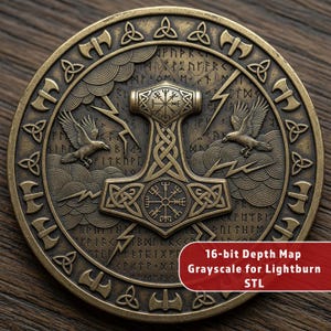 May include: A bronze-colored round coin featuring Norse mythology symbols. The coin has a central image of Thor's hammer, flanked by ravens and lightning bolts. The coin also has the text "16-bit Depth Map Grayscale for Lightburn STL".