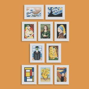 May include: A collection of framed cross-stitch art pieces, each depicting a famous painting. The artworks include Van Gogh's "Starry Night", Hokusai's "The Great Wave off Kanagawa", and others. The frames are white, and the background is orange.