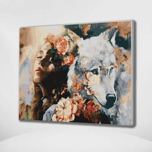 May include: A framed painting featuring a woman and a wolf, adorned with floral elements. The woman has long hair and is partially obscured by flowers. The wolf is depicted in shades of gray and white, with flowers around its face. The text "PAINTING EXPERT" is visible.