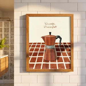 May include: Framed art print featuring a brown coffee maker illustration. The artwork includes the French text "Un café, s'il vous plaît" above the coffee maker. The background has a red and white checkered pattern.