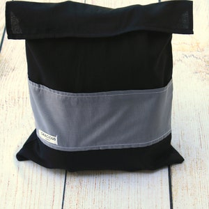 May include: Black fabric storage bag with a gray fabric band and a white label that says "Gracious Gift".