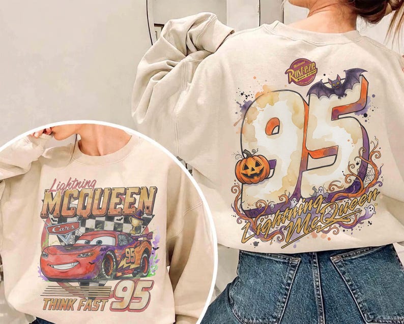 May include: A beige crewneck sweatshirt featuring a graphic of Lightning McQueen on the front with the text Lightning McQueen and Think Fast 95. The back displays a large number 95, a pumpkin, a bat, and the text Lightning McQueen.
