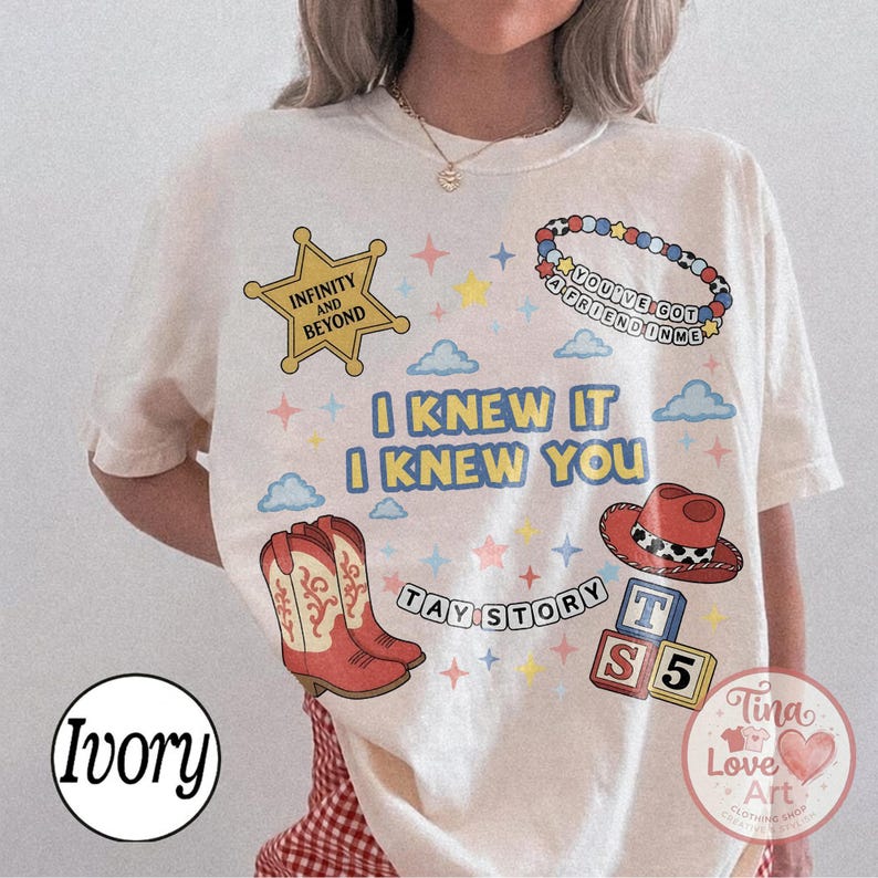 May include: An ivory t-shirt featuring a graphic print with a yellow sheriff star labeled INFINITY AND BEYOND, a beaded bracelet reading YOU'VE GOT A FRIEND IN ME, red cowboy boots, a red cowboy hat, and blocks labeled TAY STORY S 5.