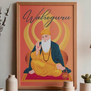 May include: A framed art print featuring a seated figure in yellow and blue robes, with a white beard and a hand raised in blessing. The artwork has the word "Waheguru" in script at the top, set against an orange and yellow background.