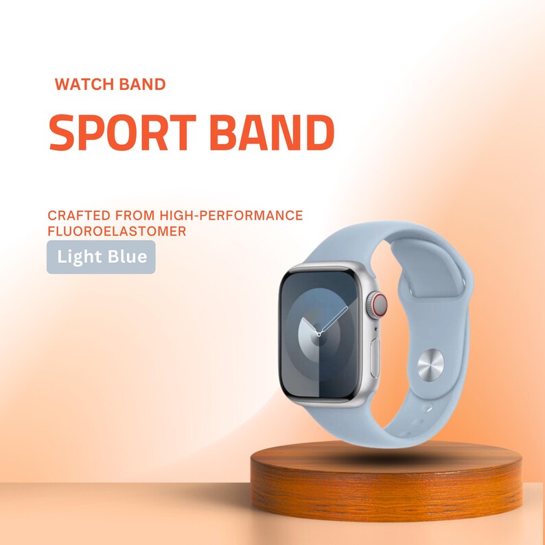 May include: A light blue sport watch band made of high-performance fluoroelastomer. The watch band is displayed on a wooden stand. The watch face is silver with a black screen. Text on the image reads "WATCH BAND", "SPORT BAND", and "Light Blue".