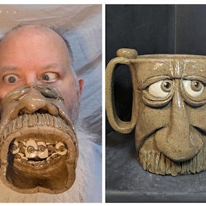 May include: A handmade ceramic mug with a sculpted face design. The mug is tan with brown speckles, featuring a large nose, beard, and expressive eyes. The handle is integrated into the design. The mug measures approximately 4 inches tall.