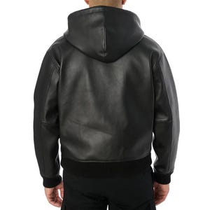 May include: A white ceramic mug with a black handle and the text "But First, Coffee" in a black, bold font. The mug is sitting on a wooden surface. The mug is approximately 4 inches tall.