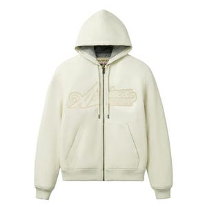 May include: Cream-colored zip-up hoodie with a hood and front pockets. The hoodie features the word "Aviation" in a stylized, raised design across the chest. The zipper is silver, and the interior of the hood is a darker gray.