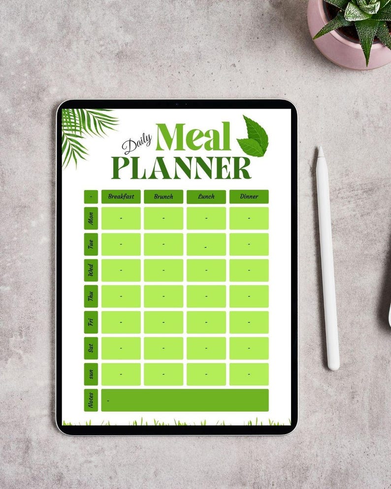 May include: A digital meal planner displayed on a tablet. The planner features a green and white design with sections for daily meals, including breakfast, brunch, lunch, and dinner. The text "Daily Meal Planner" is at the top.