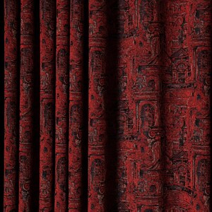 May include: Red and black patterned curtains. The fabric displays a repeating design of architectural features, including windows and columns. The curtains are hanging in vertical folds, with a dark shadow on the left.
