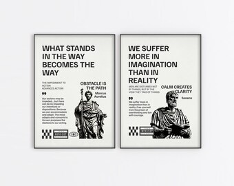 May include: Two framed art prints with black text on a cream background. One reads "What Stands in the Way Becomes the Way" with a quote by Marcus Aurelius. The other says "We Suffer More in Imagination Than in Reality" with a quote by Seneca.