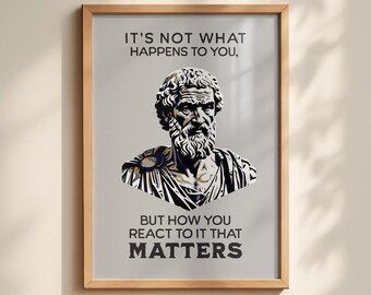 May include: A framed wall art print featuring a stylized black and white illustration of a bearded philosopher in a toga. The text above reads IT'S NOT WHAT HAPPENS TO YOU, and the text below reads BUT HOW YOU REACT TO IT THAT MATTERS.