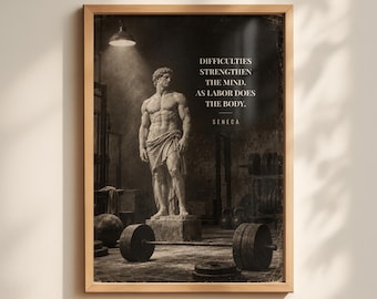 May include: A framed wall art print featuring a classical marble statue of a muscular figure standing in a gym setting with a barbell in the foreground. The text reads: DIFFICULTIES STRENGTHEN THE MIND. AS LABOR DOES THE BODY. SENECA.