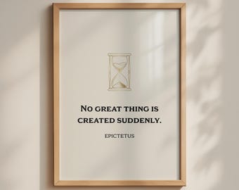 May include: A framed wall art print featuring a gold line-art hourglass icon centered at the top. Below the icon, the text reads: NO GREAT THING IS CREATED SUDDENLY. EPICTETUS. The print is encased in a light-toned wooden frame with a clean border.
