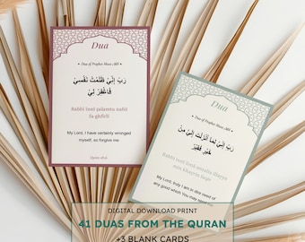 May include: Two rectangular cards with Arabic text and English translations, labeled "Dua," are displayed against a backdrop of dried palm leaves. The cards feature ornate borders and the text "41 Duas from the Quran +3 Blank Cards."