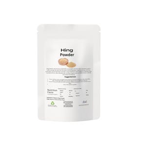 May include: A white packet of Hing Powder, a pungent spice. The packaging displays the product name, an image of the powder, and nutritional details. The text describes the spice's use in Indian cooking.