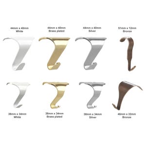 May include: A collection of eight metal stocking hooks in various finishes including white, brass plated, silver, and bronze. The hooks are labelled with dimensions: 44mm x 40mm, 51mm x 12mm, 38mm x 34mm, and 46mm x 32mm, displayed in two rows.