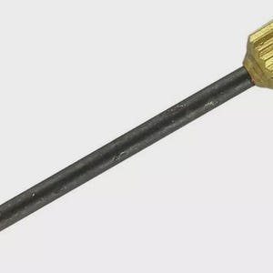 May include: A metal nail with a dark gray shaft and a brass head. The head has a ridged, cylindrical design with a flat, circular top. The nail's point is a sharp, angled tip.