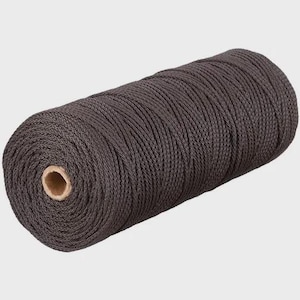 May include: A spool of dark brown macrame cord. The cord is tightly wound around a cardboard core. The texture of the cord is visible, with each strand clearly defined. The overall appearance is neat and organized, suitable for crafting projects.