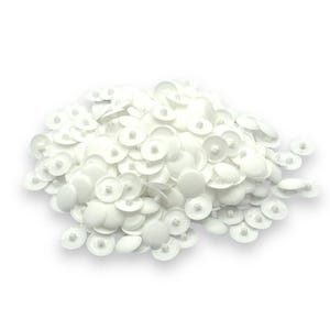 May include: A collection of white plastic snap fasteners. Each fastener features a circular, flat top and a central post. The fasteners are arranged against a white backdrop, giving a clean and organized look. These are often used in sewing and craft projects.