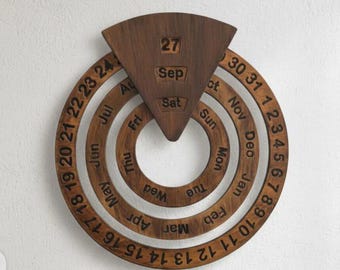 May include: A wooden perpetual calendar with a dark brown finish. The calendar features rotating rings with months, days, and dates. The current date is September 27, Saturday. A unique and decorative wall hanging.
