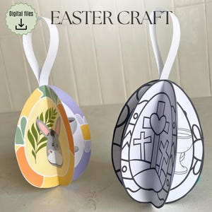 May include: Two Easter egg ornaments. One egg features a donkey and floral design, the other has a cross and chalice design. Both have white ribbon hangers. The words "Easter Craft" are at the top left, with a digital files download icon.